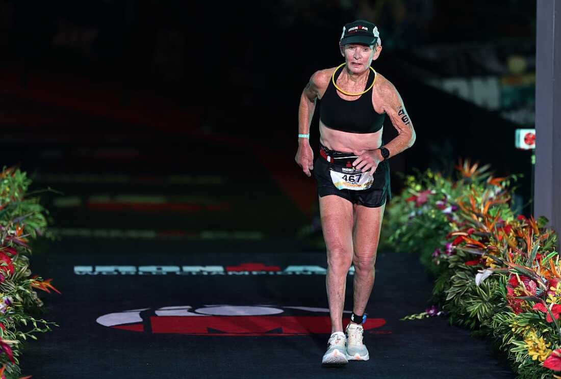Natalie Grabow completes the Ironman World Championship women's race on October 11, 2025, in Kailua-Kona, Hawaii. She's wearing black shorts, a black sports bra and sneakers.